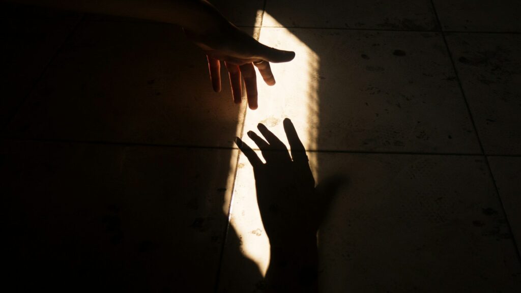 SEO process step 1, search position audit: hands reaching into a beam of light
