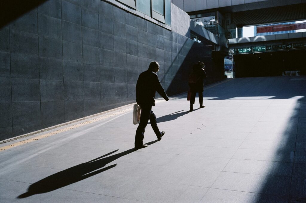 SEO process step 3, execution and optimisation: people walking through a sunlit underpass
